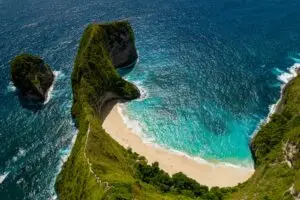 An aerial view of a beach and cliffs in the ocean
